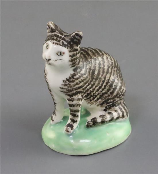 A rare Lowestoft porcelain figure of a seated tabby cat, c.1780, H. 5.9cm, one ear restored, shallow chip to base
